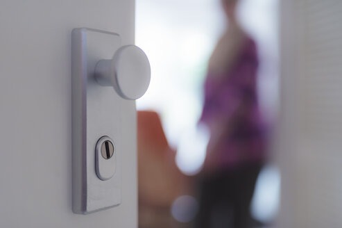 View through open apartment door to senior woman - FRF000216