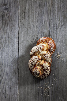 Braided pretzel pastry with sesame on wood - CSF024802