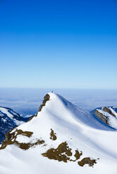 Germany, Bavaria, Allgaeu, Allgaeu Alps, couple standing on summit in winter - WGF000619