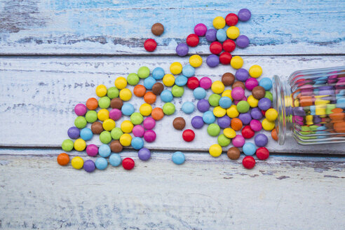 Smarties and candy jar on light blue wood - LVF002975