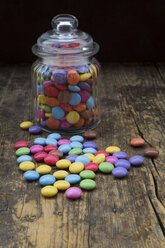 Smarties and candy jar on wood - LVF002982