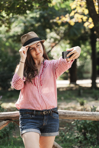 Woman taking a selfie with her smartphone stock photo