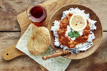 Seitan Tikka Masala on rice with soy yogurt and served with paratha breads and tea - HAWF000708