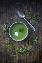 Cress soup in bowl on dark wood - LVF002999