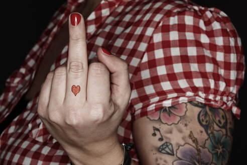 Woman with tatoos giving the finger - STK001206