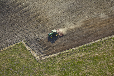 Germany, Bavaria, Aerial view of tractor on field stock photo