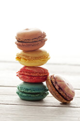 Stacked colorful macarons on wood - CSF024860