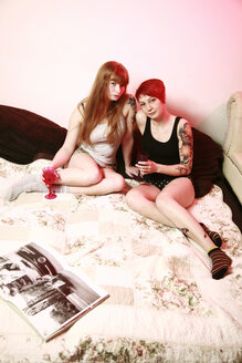 Two female friends relaxing on a blanket at home - VEF000041
