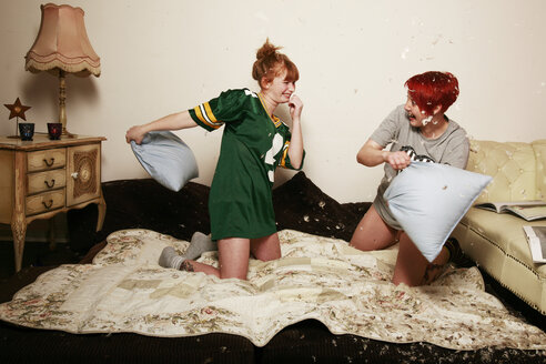 Pillow fight between two female friends at home - VEF000051