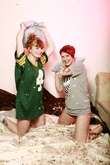 Pillow fight between two female friends at home - VEF000053