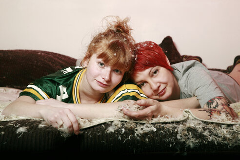 Portrait of two female friends after pillow fight at home - VEF000054