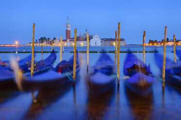 Italy, Venice, San Giorgio Maggiore with gondolas at night - RUEF001520