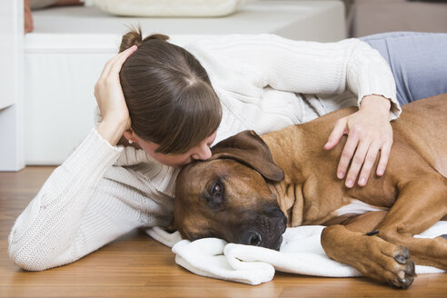 Woman caressing her Rhodesian Ridgeback dog - JTLF000054