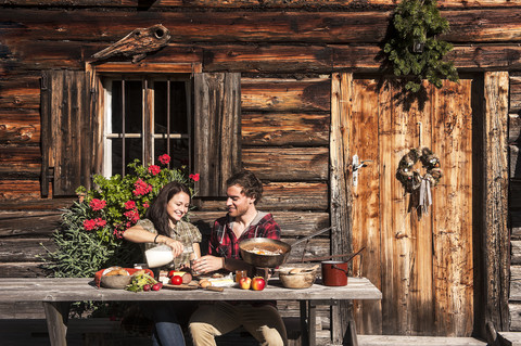 Austria, Altenmarkt-Zauchensee, couple having a break at alpine cabin stock photo