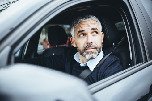 Mann im Auto schaut nach oben - MBEF001322