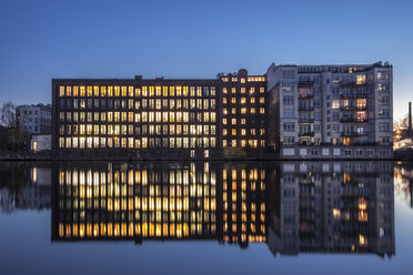 Germany, Berlin, lighted office building and water reflections in the evening - ZMF000375