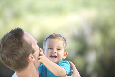 Father holding little boy outdoors - ZEF003760