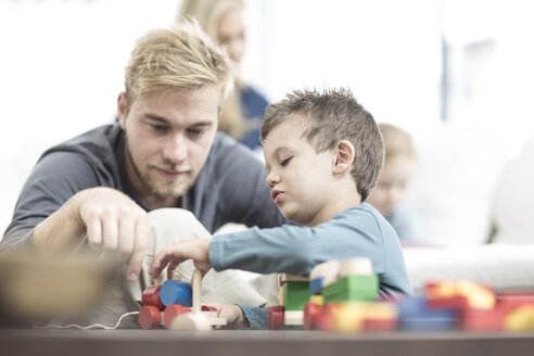 Father and little son playing with wooden toys - ZEF004012