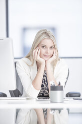 Portrait of businesswoman in office at desk - ZEF004638