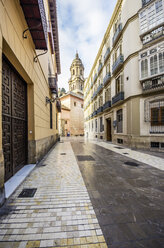 Spain, Andalusia, Malaga, Old town, alley and Cathedral of Malaga in the background - THAF001273