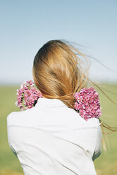 Rückansicht einer Frau mit Blumen im Freien - JPF000026
