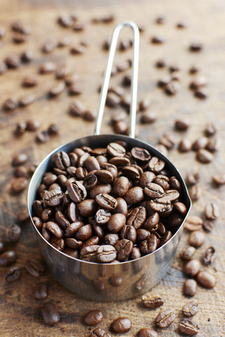 Measuring cup of coffee beans stock photo