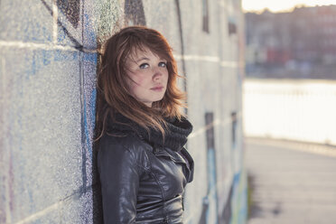 Germany, Berlin, teenage girl leaning at graffiti wall - MMFF000521