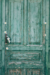 Grüne alte Holztür mit weißen Blüten verziert - JPF000025