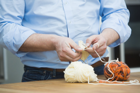 Man's hands knitting stock photo