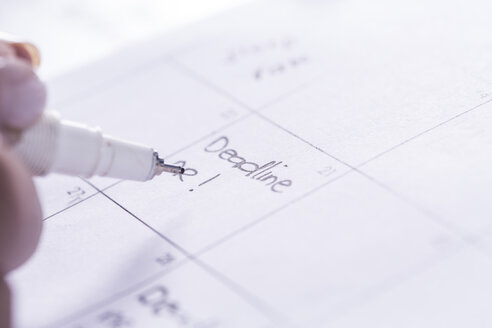 Woman noting date in day planner - ZEF003707