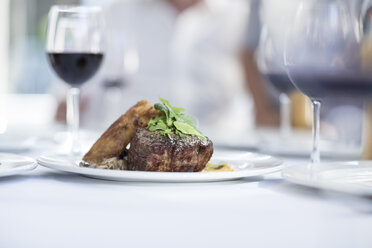 Steak and red wine on table in restaurant - ZEF004091