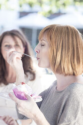 Young woman eating cup cake - ZEF004110