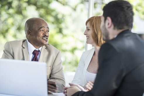 Businesspeople discussing work at business lunch - ZEF004150