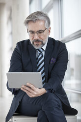 Businessman using digital tablet - RBF002557