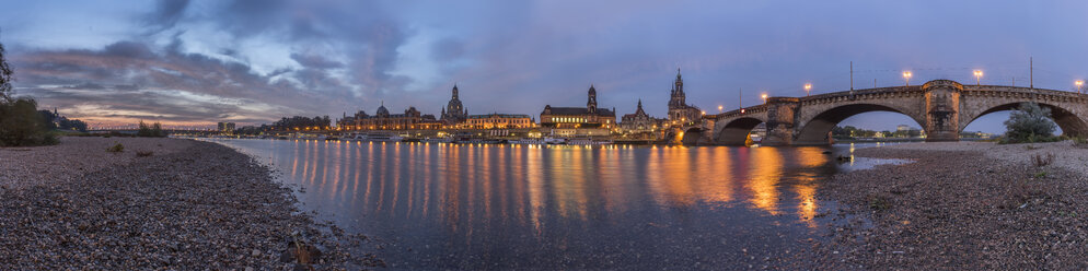 Germany, Dresden, view to lighted Old city with riverside of Elbe River in the foreground at morning twilight - PVC000316