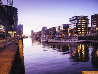 Germany, Hamburg, Magellan Terraces at the Harbour city at dusk - KRPF001380