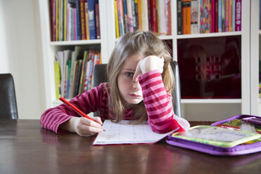 Frustrated girl doing homework - SARF001563