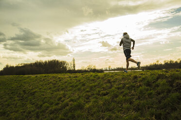 Germany, Mannheim, young man jogging - UUF003623