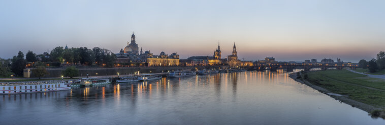 Germany, Dresden, view to lighted city with Elbe River in the foreground in the evening - PVCF000348