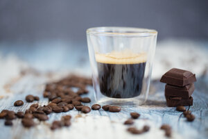 Glass cup of espresso, roasted coffee beans and dark chocolate on wood - LSF000012