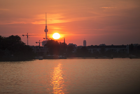 Deutschland, Berlin, Blick auf die Spree bei Sonnenuntergang mit Fernsehturm im Hintergrund, lizenzfreies Stockfoto