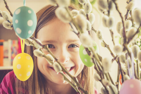 Portrait of smiling girl behind Easter bouquet - SARF001547