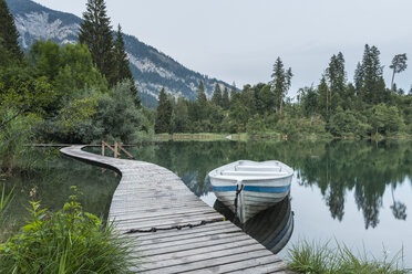 Switzerland, Grisons, Lake Cresta, wooden boardwalk and boat - KEBF000076