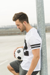 Young man with soccer ball outdoors - UUF003676