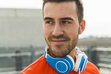 Smiling young man with headphones - UUF003710