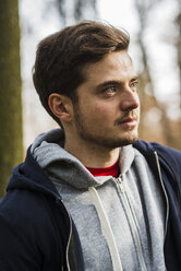 Young man wearing hooded jacket outdoors - UUF003719