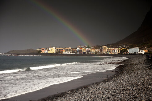 Spain, Canary Islands, La Gomera, Valle Gran Rey, Rainbow over beach and village Playa - PCF000118