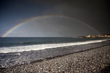 Spain, Canary Islands, La Gomera, Valle Gran Rey, Rainbow over beach and village Playa - PCF000119