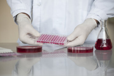 Scientist with liquid in test tubes - RBF002605