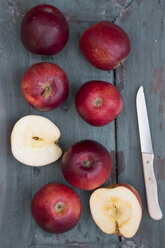 Red apples and knife on dark wood - SARF001584